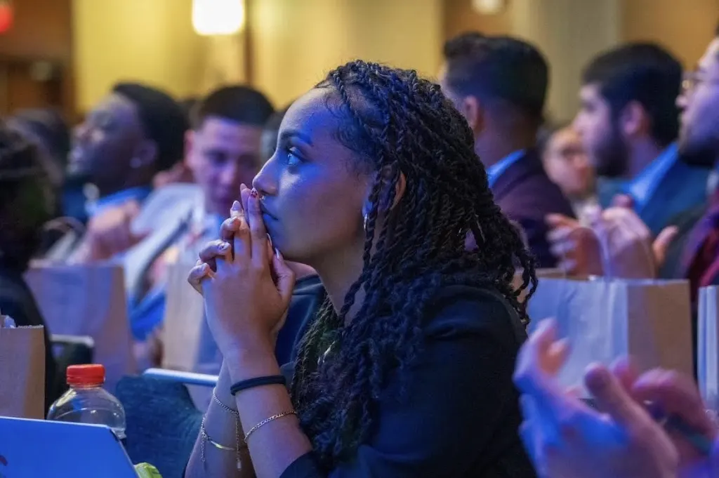 An attentive attendee listening at a White Whale Marketing event
