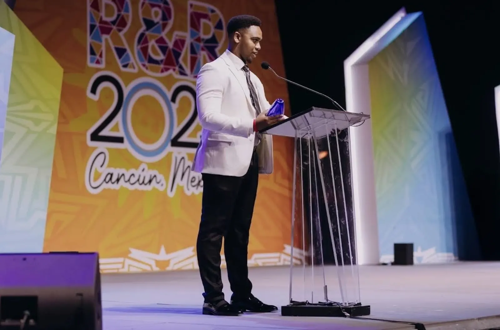 A White Whale Marketing representative receiving an award on stage